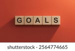 the word GOALS is written on a wooden cubes structure.close up of wooden elements,Business Concept.3D rendering on red background.