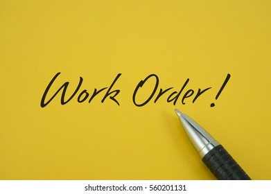 Work Order! Note With Pen On Yellow Background