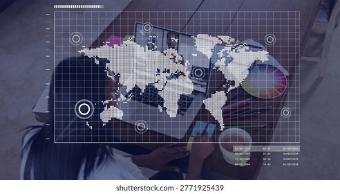 Working designer in white top using smartphone, open laptop on desk, color wheel, HUD overlay. Creative, studio, palette, markers, grid, hybrid, workspace