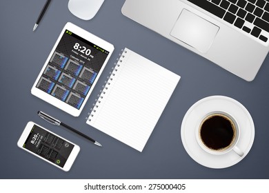 Workplace with tablet computer and mobile phone on table