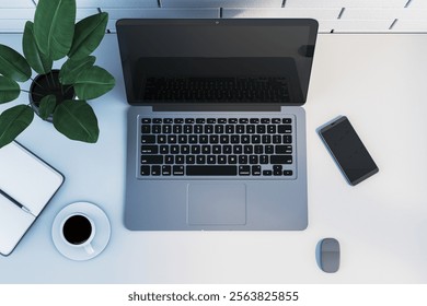 Workspace featuring a laptop, smartphone, coffee cup, notebook, pen, desk plant, modern clean table setting, bright interior, minimal concept. 3D Rendering.