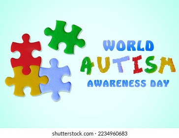 World Autism Awareness Day. Colorful puzzle pieces and text on light blue background, top view - Powered by Shutterstock