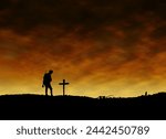 World War One Silhouette of British Soldier Standing in Front of Provisional Grave of Comrade on The Western Front Below Cloudy Skyline At Dusk or Dawn