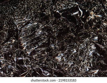 Worn Abstract Background. Creased Texture. Crumpled Plastic Film. Orange White Ripples On Gritty Dark Black Illustration Overlay.