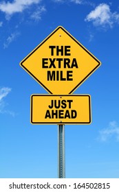 Yellow Cautionary Road Sign The Extra Mile Just Ahead