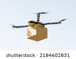 Yellow smart copter flying with package box in the sky, side view. Modern autonomous bot for drone order delivery. Mockup copy space. 3D rendering