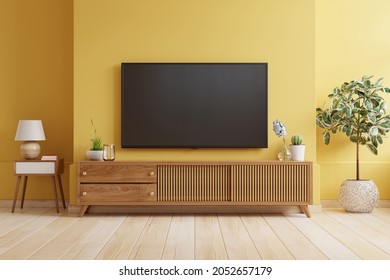 Yellow Wall Background,TV Is Mounted On A Wooden Cabinet In A Modern Living Room.3D Rendering