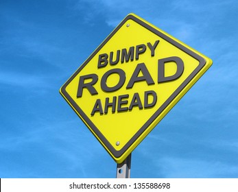 A yield road sign with "Bumpy Road Ahead"