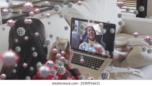 Young biracial woman having a video call with a teenage Caucasian girl. They are sharing a moment of connection despite the distance, symbolized by floating graphics. - Powered by Shutterstock