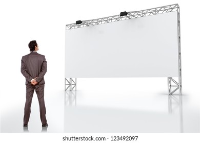 Young Business Man Looking At Blank Billboard