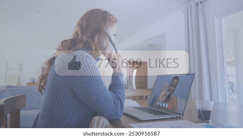 Young Caucasian woman in a video call with an African American man. They are engaged in a conversation, with a social media likes counter overlay. - Powered by Shutterstock