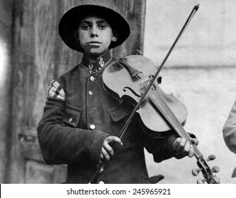 A Young Christmas Street Fiddler, Belgrade, Serbia. Photo By Lewis Hine. Dec. 1918.