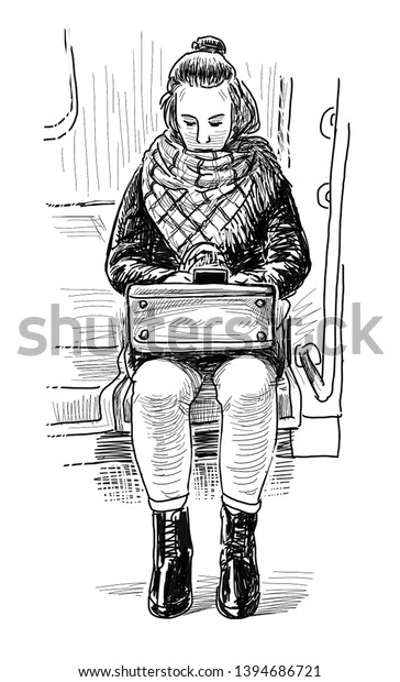 Young city dweller with a mobile phone sitting in a\
subway car