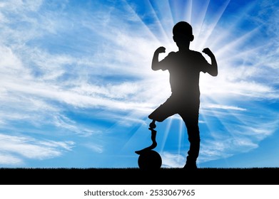 A young disabled boy with a prosthetic leg defies limitations by standing tall and proud with his foot on a ball. Image is a powerful reminder that anything is possible with determination and persever - Powered by Shutterstock