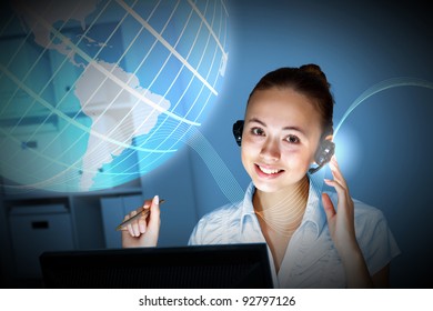 Young woman in business wear in headset working with computer - Powered by Shutterstock