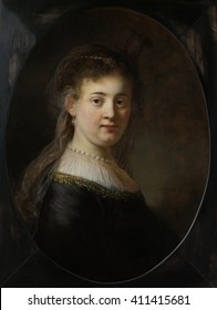 Young Woman in Fantasy Costume, by Rembrandt van Rijn, 1633, Dutch painting, oil on panel. The model for the painting is probably Rembrandt's wife Saskia van Cuylenburgh. Her clothing, the thin veil