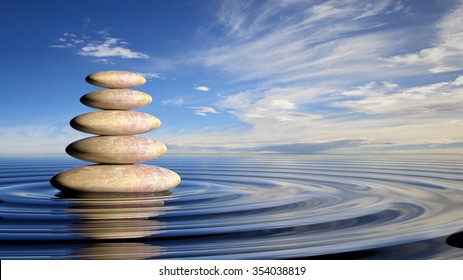 Zen stones stack from large to small  in water with circular waves and peaceful sky.