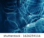 The abstract​ of surface​ blue​ water​ reflected​ by​ sunlight​ in​ deep​ ocean​ for​ background​
