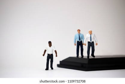 The social problem concept of racism. Miniature people of different races.