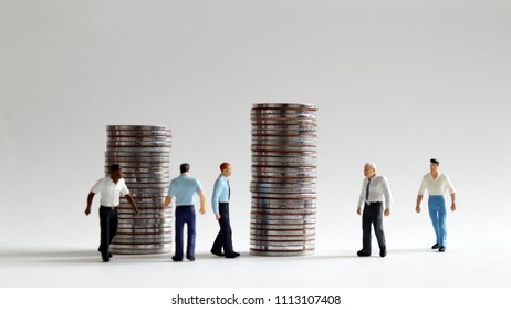 Image of busy rush hour. Pile of coins and busy walking miniature people.