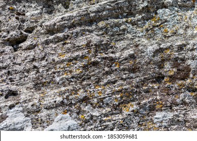 Old aged grunge deserted cobble boulder dry wall of the castle town. Crushed rugged relief grungy block, scary ruined quarry stone, built older decrepit cement waste facade, dirty crumbling fort side