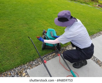 The man is mowing the lawn