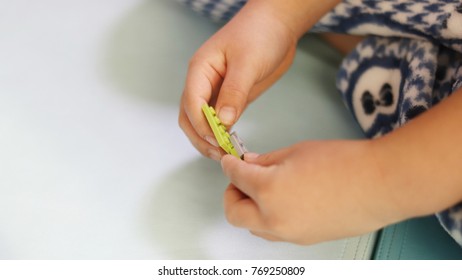 Hands of a child playing with block toy.