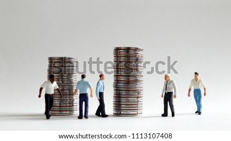 Image of busy rush hour. Pile of coins and busy walking miniature people.