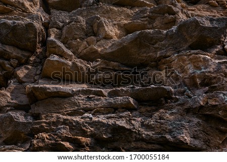 Dark texture cut blocks trench. Mining cliff of rough rock crash surface. Coarse detail quarry backdrop. Heavy grunge damage natural wall cave. Crack antique medieval marble front facade for design 3d