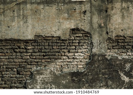 Aged scratched chipped front of fence for 3D dark design. Cracked uneven flaked rot wall of an old castle grunge loft. Brushed peeling dirty ruined exposed stucco on shabby medieval scary street city
