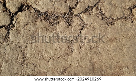 Grunge rustic vintage ancient bad relief path. Outdoor aged scuffed dirty hard dry clay rocky floor trail.Crannied bumpy cragged soil footpath. Textured shabby rough craggy mud dust 3D medieval design