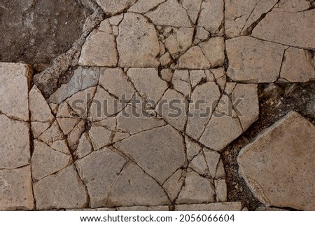 Old aged damaged marble bumpy uneven blocks. Trip pitted grunge granite tile cobble. Cragged grimy retro cranny frayed run track. Crannied dirtied shabby smashed gaping rustic big holes for 3d design