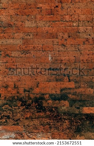 Old grungy retro dirty red brick wall of ancient city. Uneven pitted peeled surface brickwork of cellar worn. Cracked shabby clay blocks. Hard bumpy messy ragged holes brickwall for 3D grunge design Stock photo © 