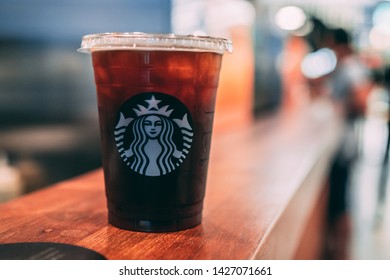 01 June 2019; Bangkok Thailand: Starbucks Iced Americano Take-away Coffee Cup at Starbucks Cafe Coffee Shop