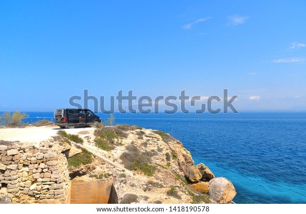 \
01.09.2018. a solitary car on the cliff with the\
background of Mediterranean sea and blue sky on the island of\
Favignana Sicily\
Italy