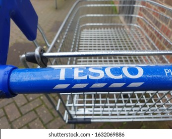 01/31/2020 Portsmouth, Hampshire, UK A close up of the handle of a Tesco shopping trolley or shopping cart showing the Tesco logo 