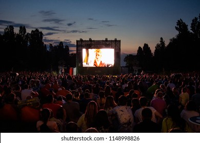 02 August 2018-Bucharest, Romania. People waiting and watching in the public park Herastrau for the movie to start on the projection screen of the open air cinema