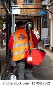 03/11/2020 Winchester, Hampshire, UK A Royal Mail Postman Delivering Mail In The Street