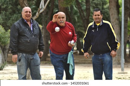 03/23/2017 Alicante Spain. Several Retirees Play The Game Of Petanque In The Public Park 