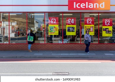 04/01/2020 Portsmouth, Hampshire, UK People Standing Two Meters Apart Or Social Distancing Whilst Queuing To Buy Food At An Iceland Supermarket