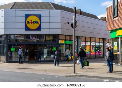 04/01/2020 Portsmouth, Hampshire, UK Shopper Queuing Outside A Lidl Supermarket Standing Two Meters Apart During The Covid-19 Or Coronavirus Pandemic