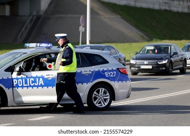 04.18.2022 wroclaw, poland, A traffic police officer during a road traffic supervision with a police car.