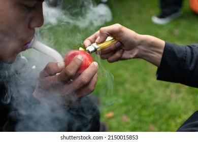 «Bogotá, Colombia»; 04.20.2022 : Man Smokes Marijuana From A Bong And An Apple At 420 Commemoration In Bogotá»