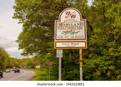  04-28-2021 Point Of Rocks, MD, USA: Welcomes You Road Sign On The Scenic Byway US Route 15 At The Border Of Maryland And Virginia.  It Has MD Flag And Says Open For Business. 