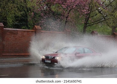 05.01.2021 wroclaw, poland, The car falls into a pool of water on the road, causing a splash of water after rain.