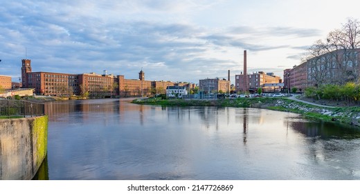 05-08-2021. Nashua, New Hampshire, USA. Panorama Of The Historical Part Of Nashua Today. Numerous Buildings Of A Cotton Mill With A Clock Tower In An Old Industrial Park On The Nashua River