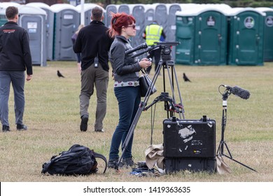 06/06/19 Portsmouth, Hampshire, UK A Female Camera Operator Setting Up Camera Equipment Before Filming An Outdoor Event 