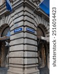 06-09-2024 Zurich, Switzerland. Paradeplatz and Bahnhofstrasse street sign on the Credit Suisse bank building street corner or intersection. Low angle, no people.