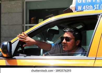 06.14.2013, New York, USA. Hindu Taxi Driver Shows The Direction Of Movement With His Arm. Urban Transport..