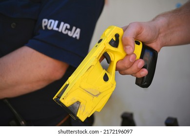 06.24.2022 Wroclaw, Poland, A Policeman On Duty With An Electric Stun Gun. Tazer. Taser